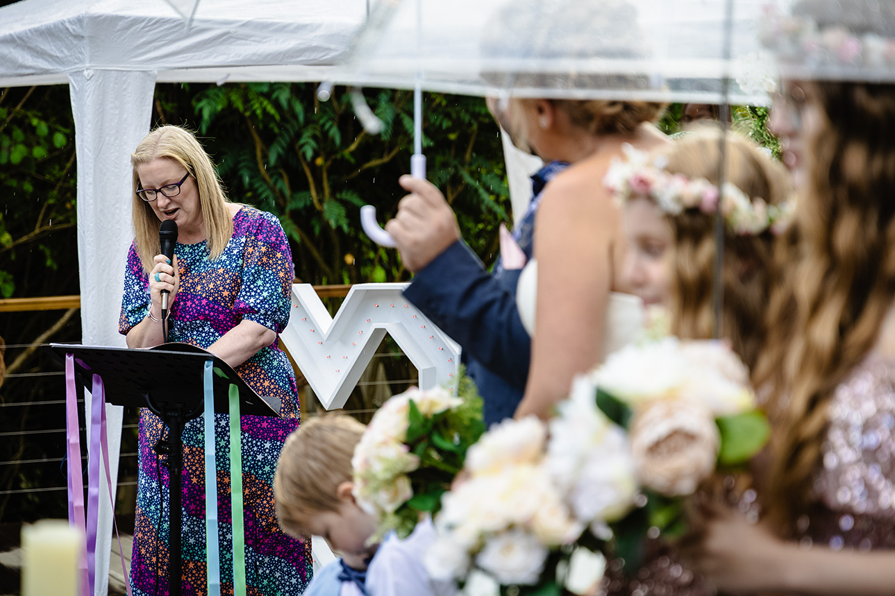 Deb Reed Celebrant Colchester Essex, speaking during the rain at Gary and Kelly's vow renewal.